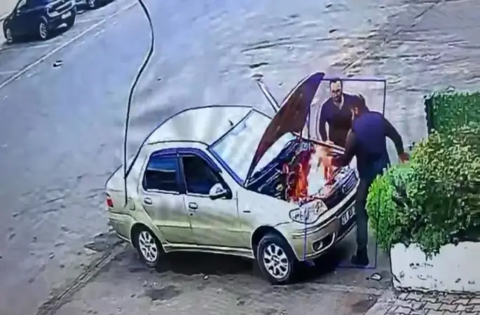 Alev alan otomobili üfleyerek söndürmeye çalıştı: O anlar kamerada
