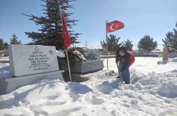 Karla kaplanan şehitlikte temizlik yaptılar
